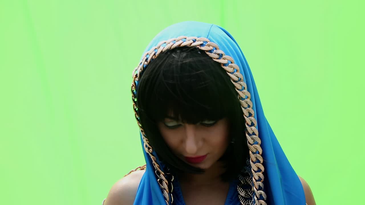 Girl in egyptian costume on a green background