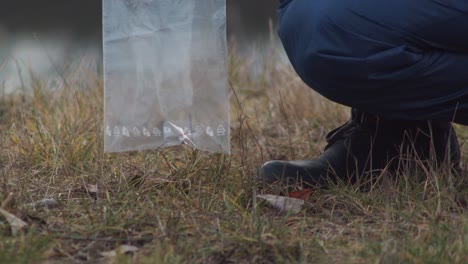 Putting-passport-into-plastic-bag,-crime-scene-investigation,-closeup-view