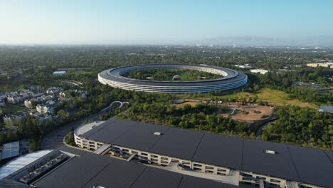 apple park hq with surrounding landscape in cupertino san jose california from an aerial drone dolly shot