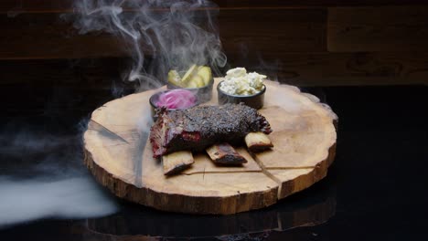 smoky hot bbq ribs on the wooden plate with sides medium shot