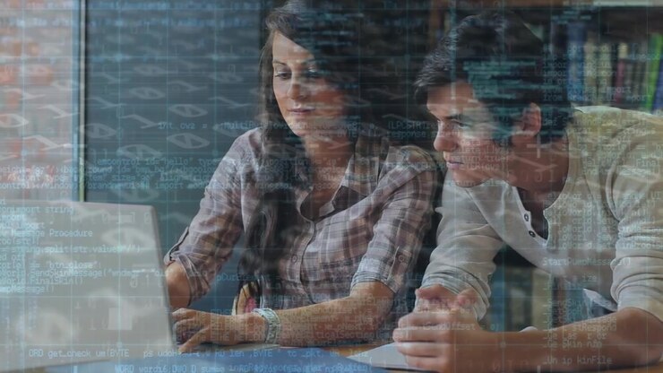 Animation of binary code and caucasian students discussing over laptop in library