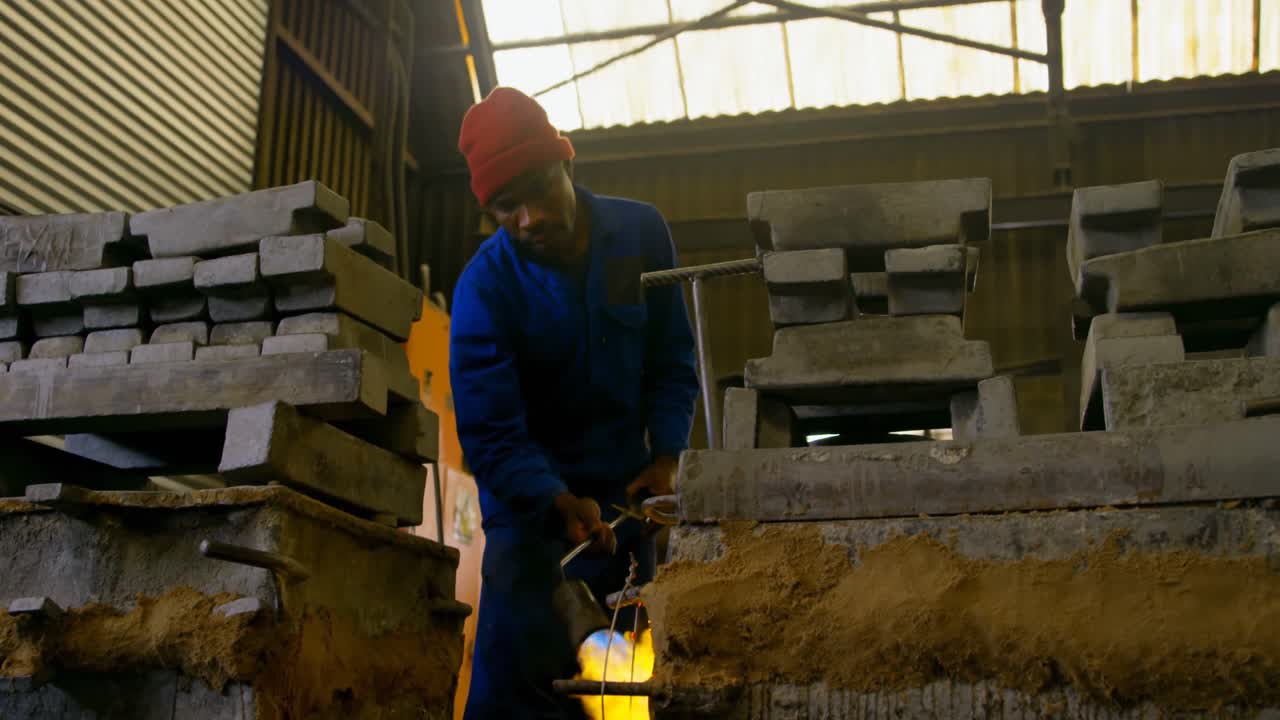 Male worker heating mold in workshop 4k