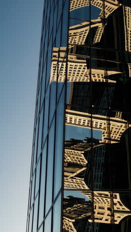 reflection of buildings in a skyscraper facade