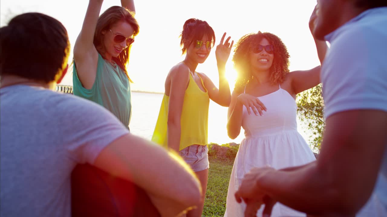 Multi ethnic students having fun at beach party
