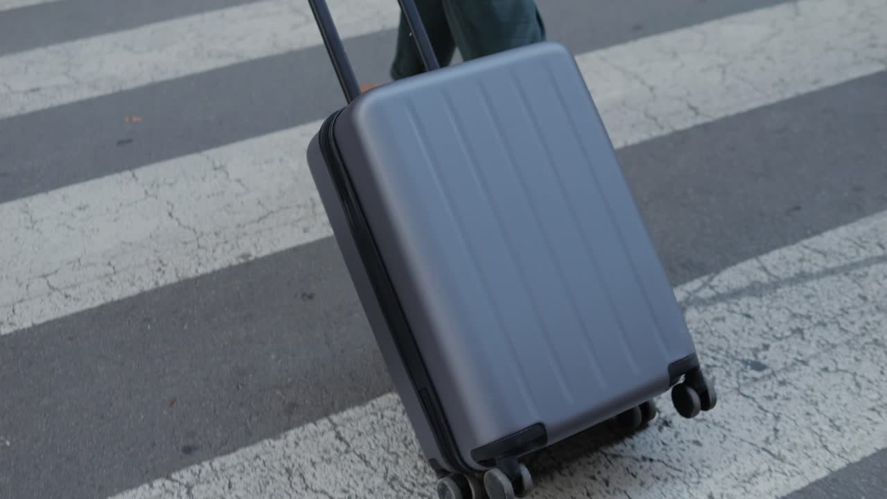Person with Suitcase on a Crosswalk