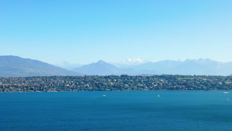 cologny town on the left bank of lake geneva with mont-blanc in the background in switzerland