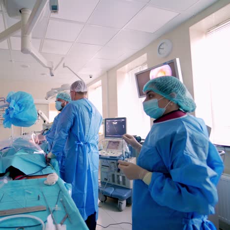 surgery in the operating room. modern medical equipment in the hospital. teamwork of doctors doing an operation to a patient and look at medical monitors.