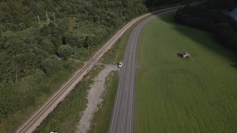 car parked along a road near romsdalen valley in norway - aerial drone shot