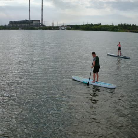 standup paddle board surfing. people standing firmly on sup board and paddling