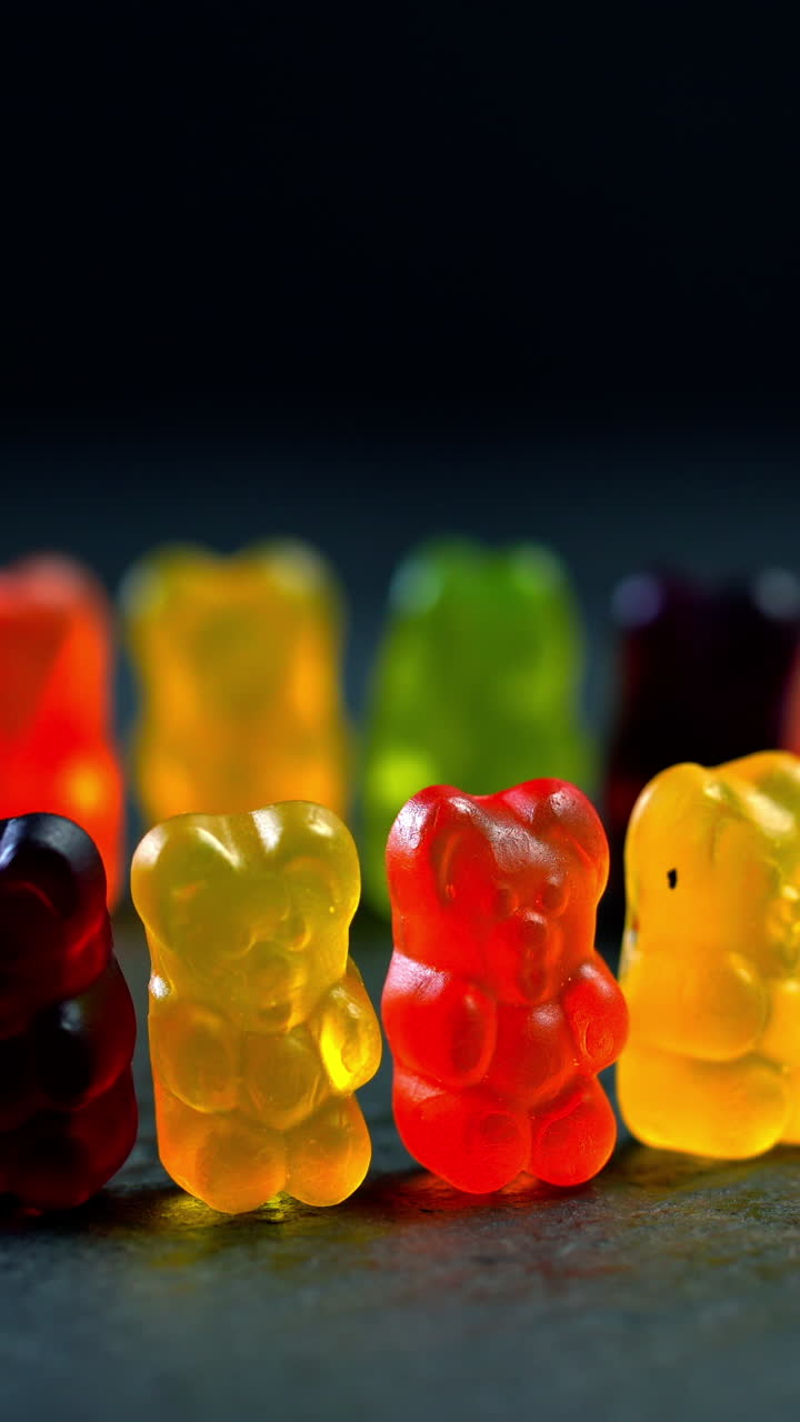 Gummi bears. Multicolored fruit gummy candy. Vertical video