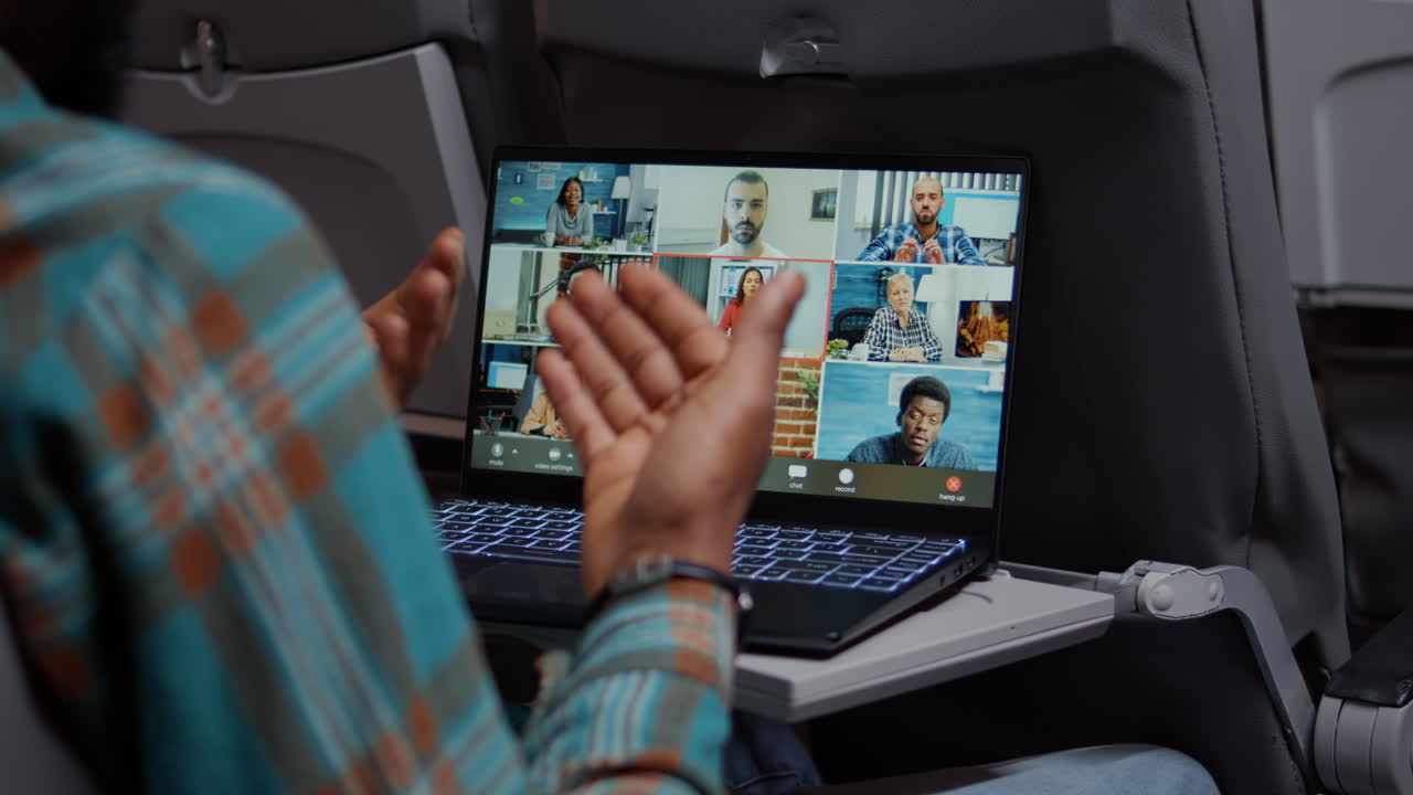Entrepreneur in airplane attending online videocall meeting