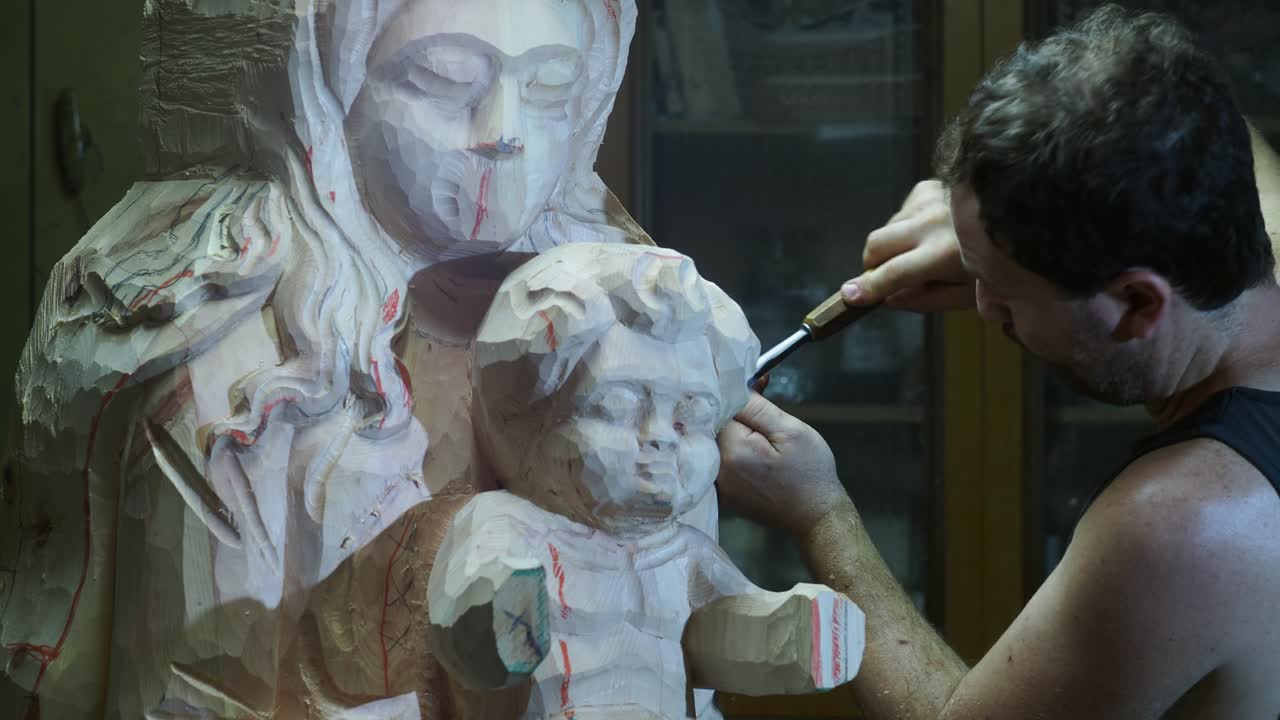 Skilled craftsman carefully carving wooden statue, meticulously shaping intricate sculptural details using traditional woodworking techniques with precise chisel movements