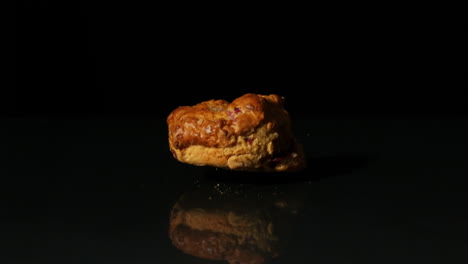 Scone-falling-on-black-background