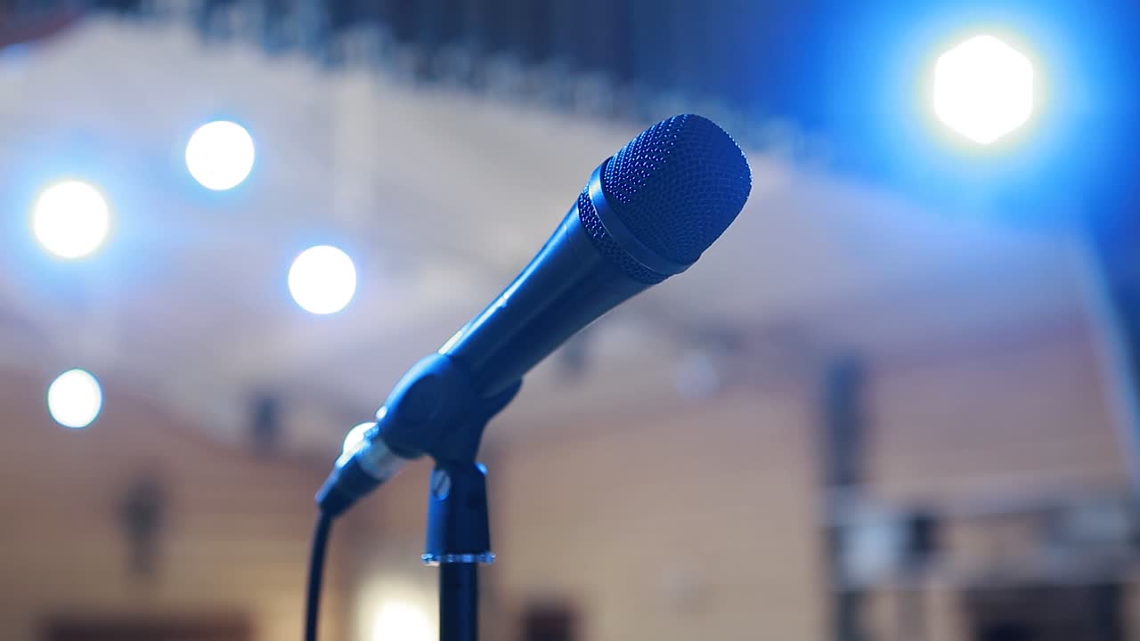 Microphone In Concert Hall. Stage lighting, equipment and microphone stand in a night club