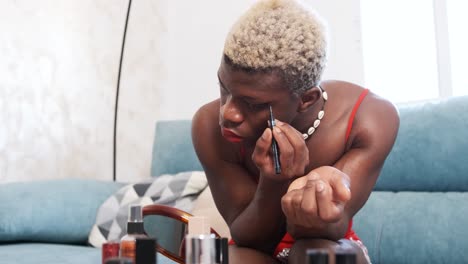 person applies eyeliner in a focused beauty routine at home