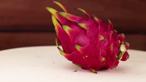 dragon fruit rotates on a wooden table