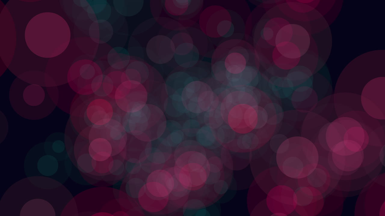 An abstract image showcasing red and blue circles against a dark backdrop, creating a blurred effect. The shallow depth of field adds a sense of mystery and artistic appeal to the composition