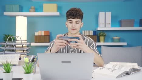 the teenager playing on the phone during the lesson hangs up and continues his lesson.