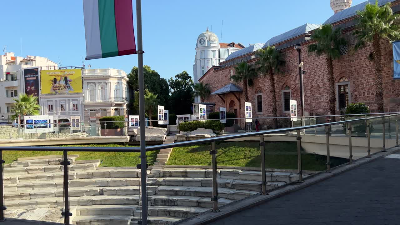 Beautiful view of the Roman Stadium Square on the main pedestrian street with Dzhumaya Mosque and the Ancient Roman Stadium. The Ancient Stadium of Philippopolis. Dzhumaya Square. Jumayata.
