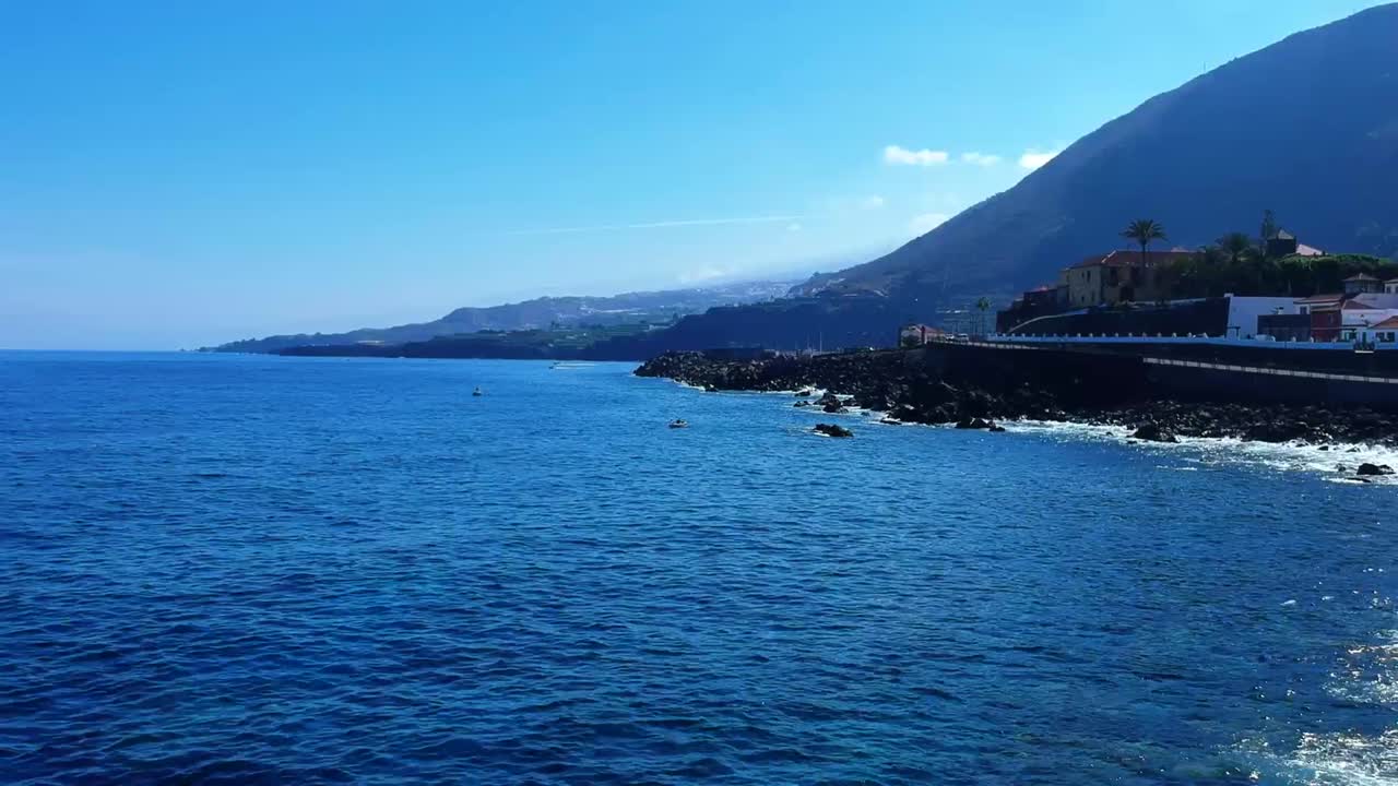 Aeriel drone footage at Garachico - Caleton (Tenerife) next to the blue ocean as the waves hit the rocks in the water