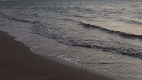 waves crashing along the shore at dusk in maui hawaii