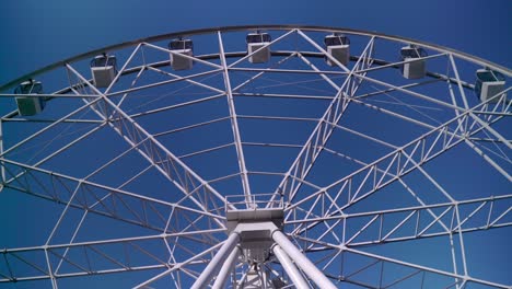 in the park, a large ferris wheel is spinning slowly. high-altitude view wheel
