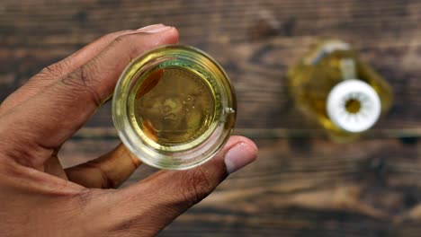 Holding-a-sunflower-oil-bottle-top-view