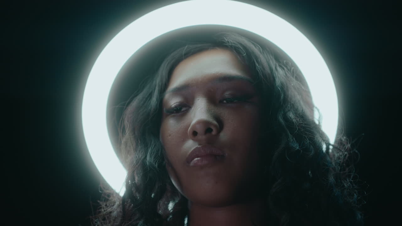 Young Asian Woman Posing under Ring Light in the Darkness