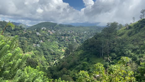 handheld shot looking across valley in ella sri lanka on sunny and cloudy day