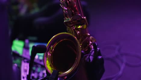 saxophone on stage under purple lights