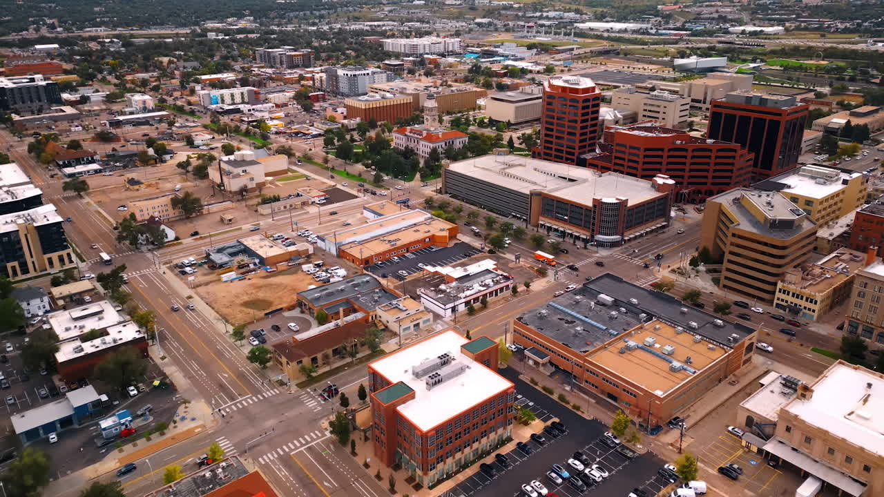 Vast cityscape of Colorado Springs, Colorado, USA. Numerous cars move by the wide highways of the urban landscape