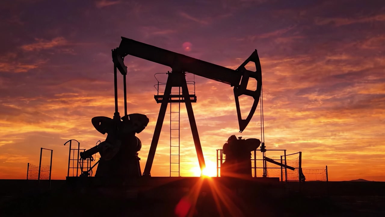 Silhouetted Oil Pumpjack Against a Stunning Sunset: A Modern Exploration of Energy Extraction and the Beauty of Nature's Palette