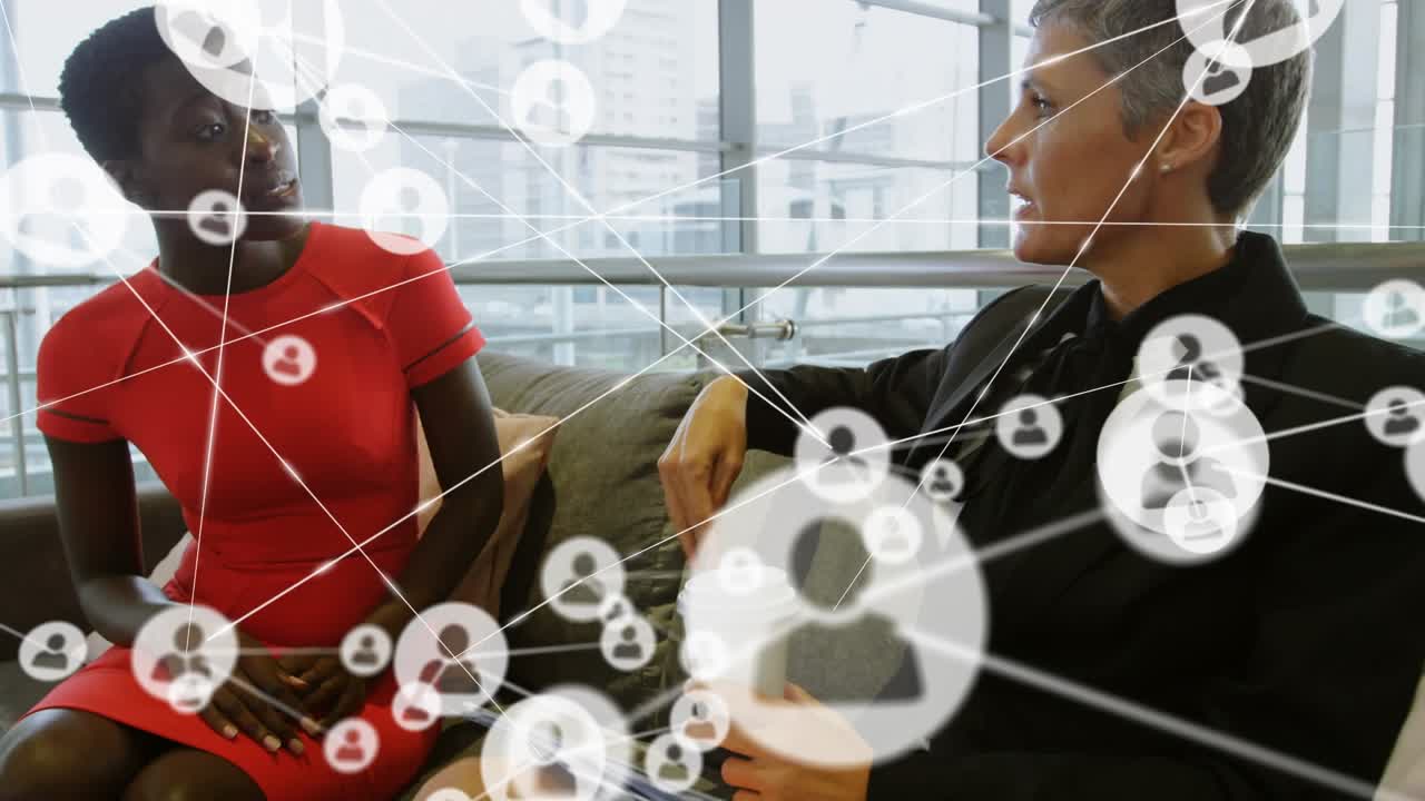 Animation of network of connections with icons over diverse business people working at office