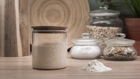 sourdough starter in a glass jar doubling its volume after feeding - time-lapse