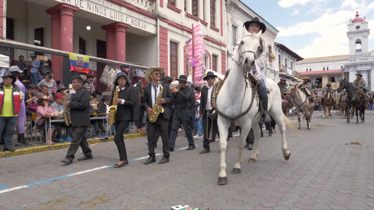 Experience a cinematic perspective as a gimbal-mounted camera gracefully approaches a Chagra rider on a white horse, elegantly dressed in a white shawl and chagra hat