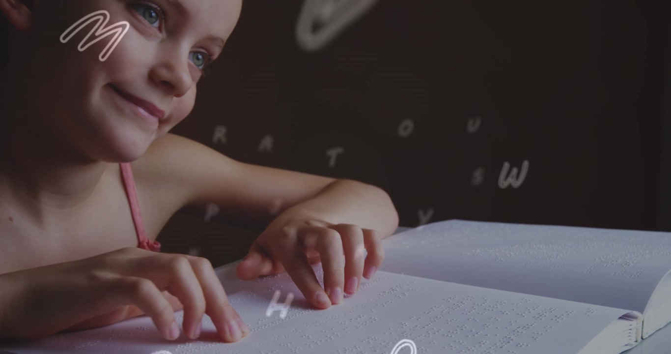 A girl is reading a braille book in a classroom