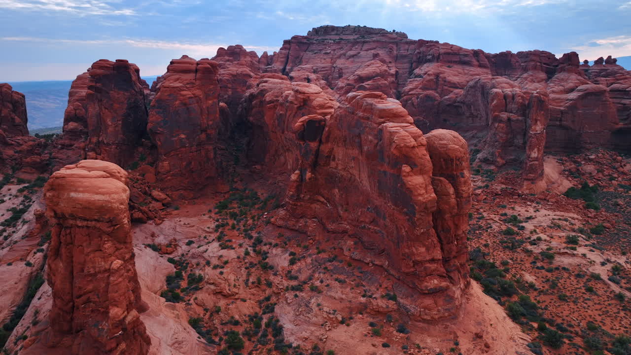 Flight around the stunning red rocks in the dry desert. Spectacular canyons of the Arches National Park, Utah, USA from drone