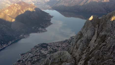 kotor bay fiord amongst high rocky mountains at late afternoon in montenegro