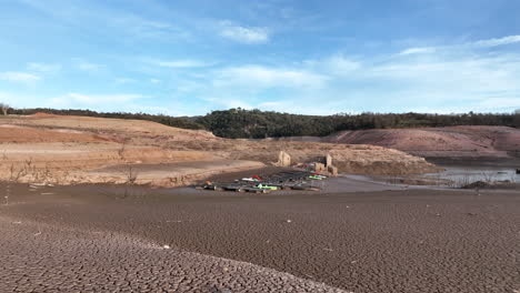 sau reservoir, severe drought conditions in catalonia region, pier on dry ground