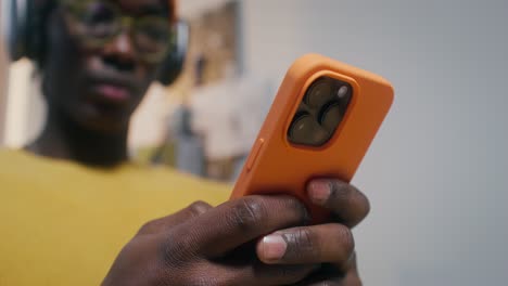 young person using smartphone and headphones