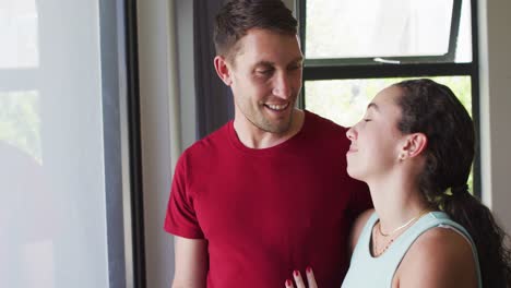 Happy-caucasian-couple-talking-and-looking-out-the-window