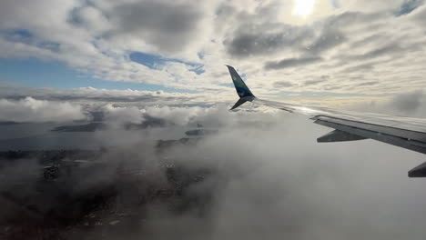 Airplane-approach-to-Seattle-with-runway-landing,-wing-tip-view