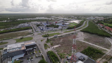 Aerial-Beside-Radio-Mast-Tower-Beside-CEPM-Electric-Plant-And-Traffic-Going-Past-On-Carretera-Higuey-Miches