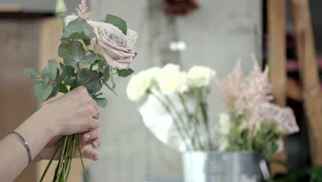 young florist assembles a bouquet