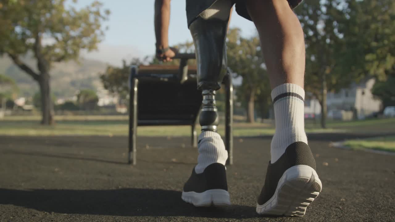 Low section view man with prosthetic leg stretching