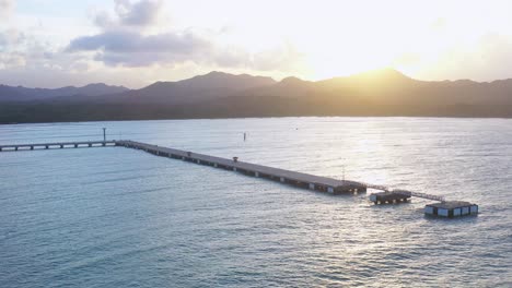 Forward-flight-with-view-to-the-embarkation-port-of-the-cruise-ships-in-Puerto-Plata,-Dominican-Republic,-beautiful-sunset