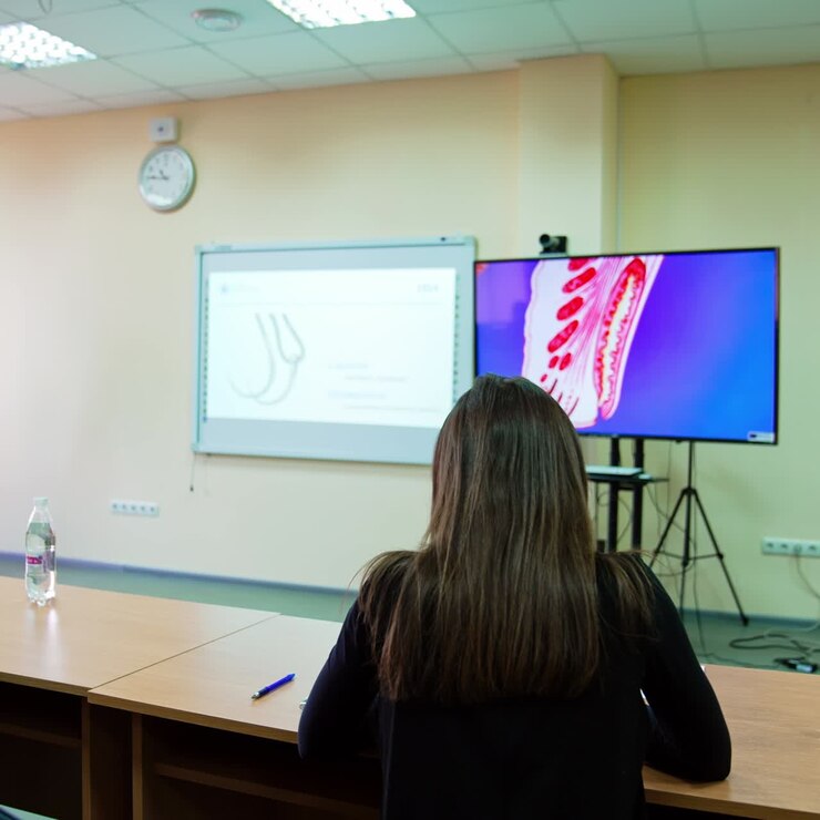 Students studying ophthalmology in medical university. Big screen showing the images of an eye
