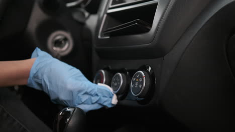 cleaning car dashboard with gloves