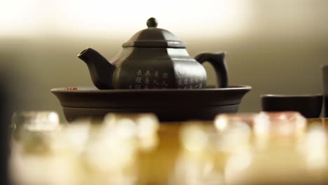 chinese tea set and glass chinese chess on the golden chess board