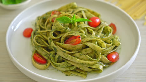 fettuccine spaghetti pasta with pesto sauce and tomatoes - vegan and vegetarian food style